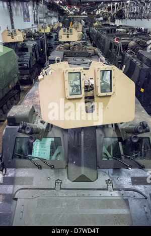 The Vehicle Deck onboard Assault Ship HMS Bulwark with Viking and BV personnel carrier vehicles of the Royal marines. Stock Photo