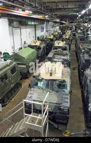 The Vehicle Deck onboard Assault Ship HMS Bulwark with Viking and BV personnel carrier vehicles of the Royal marines. Stock Photo