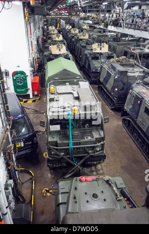 The Vehicle Deck onboard Assault Ship HMS Bulwark with Viking and BV personnel carrier vehicles of the Royal marines. Stock Photo