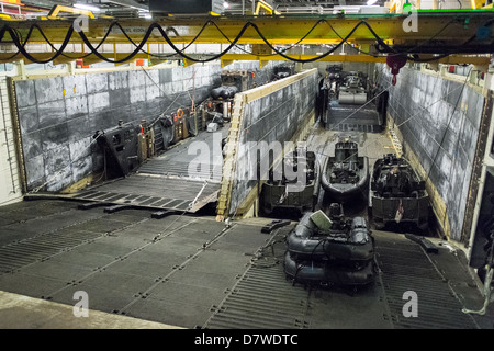 The Vehicle Deck onboard Assault Ship HMS Bulwark with Viking and BV personnel carrier vehicles of the Royal marines. Stock Photo