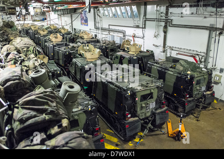 The Vehicle Deck onboard Assault Ship HMS Bulwark with Viking and BV personnel carrier vehicles of the Royal marines. Stock Photo