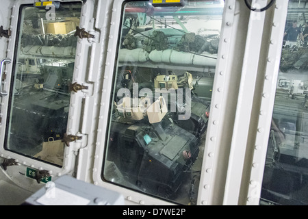 Onboard HMS Bulwark with Viking and BV armored vehicles ready for deployment seen from the Vehicle Deck Control Room Stock Photo