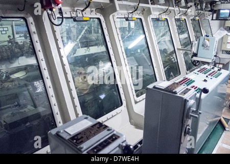 Onboard HMS Bulwark with Viking and BV armored vehicles ready for deployment seen from the Vehicle Deck Control Room Stock Photo