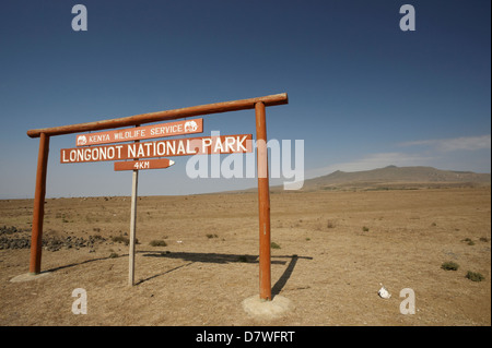 Park sign with stratovolcano in distance, Mount Longonot National Park, Nakuru, Kenya Stock Photo