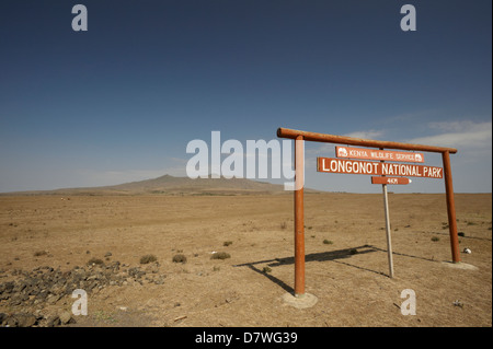 Park sign with stratovolcano in distance, Mount Longonot National Park, Nakuru, Kenya Stock Photo