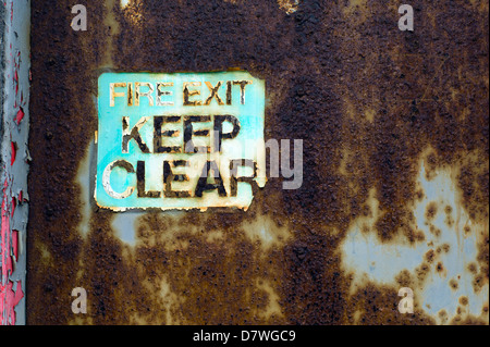 old rusty door and sign, fire exit, Brighton, UK Stock Photo