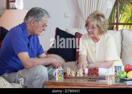 Elderly couple playing chess Stock Photo