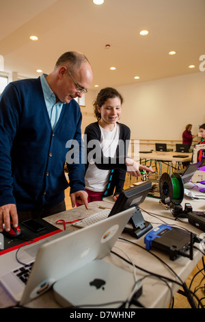 A teenage girl asking questions at a demonstration of 3D Three dimensional computer printing technology, UK Stock Photo