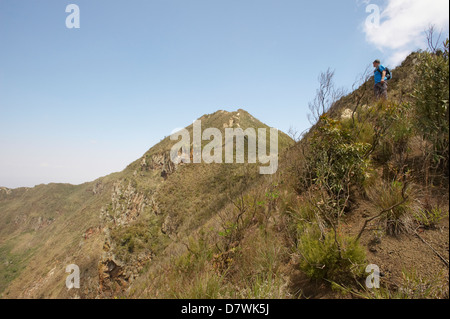 Hiker on steep slopes of crater rim of Mount Longonot, Mount Longonot National Park, Nakuru, Kenya Stock Photo