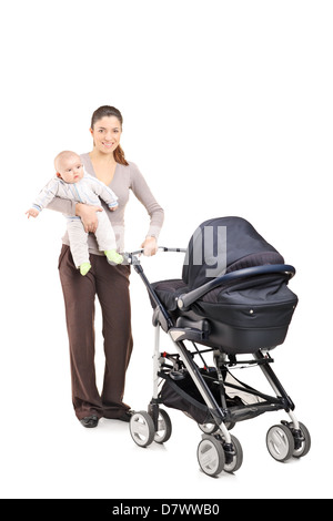 Full length portrait of a young mother with a baby and a pushchair, isolated on white background Stock Photo