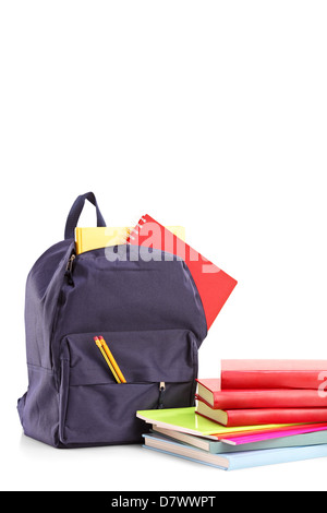 Studio shot of a school backpack with books and notebooks, isolated on white background Stock Photo