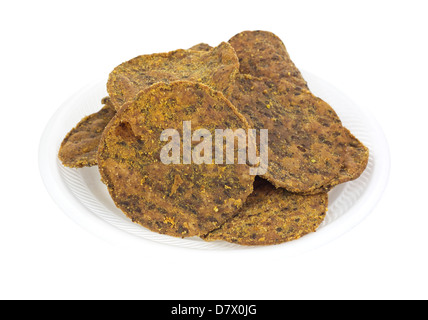 A large serving of bean tortilla chips on a white foam plate. Stock Photo