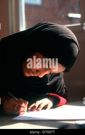 Muslim school pupil studying in class, Southwark, London, UK. Stock Photo