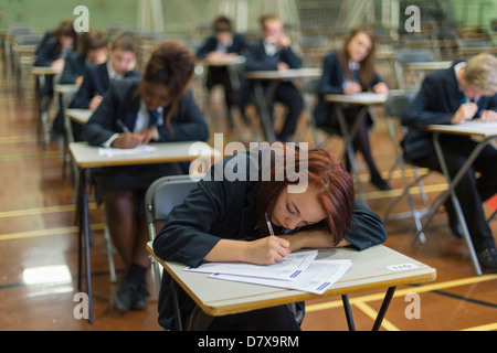 Secondary school pupils sat in a hall in exam conditions GCSE Stock Photo