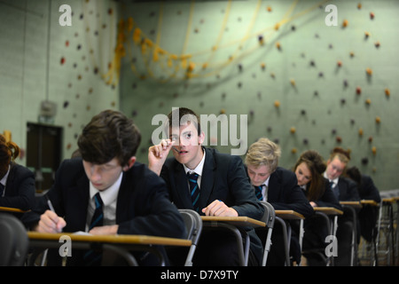 Secondary school pupils sat in a hall in exam conditions GCSE Stock Photo