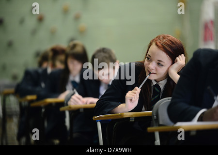 Secondary school pupils sat in a hall in exam conditions GCSE Stock Photo