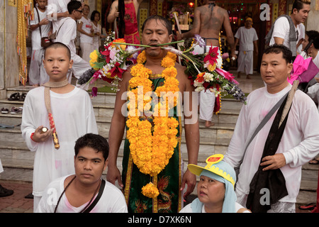 PHUKET, THAILAND OCTOBER 3 2011: A spirit medium waits to have piercings extracted at the annual Phuket Vegetarian Festival. Stock Photo