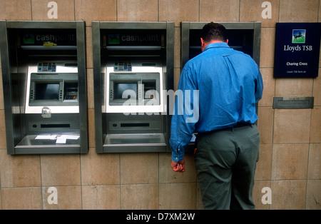 Customer using Lloyds TSB cashpoint machine, Charing Cross, London, UK. Stock Photo