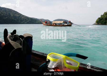 Park boats take snorkelers to the local coral reefs around the Surin islands. Stock Photo