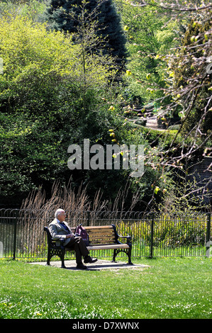 Old man sitting on a park bench Stock Photo - Alamy