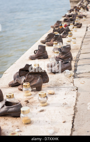 Budapest Hungary Holocaust memorial Jews Jewish people shot by Arrow Cross NAZI militia then thrown into River Danube candle Stock Photo