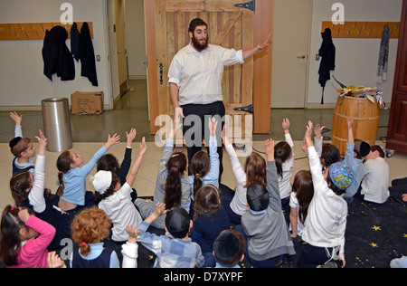 Young children get a lesson in how Torahs are made at the Jewish Children's Museum in Crown Heights, Brooklyn, New York Stock Photo