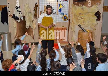 Young children get a lesson in how Torahs are made at the Jewish Children's Museum in Crown Heights, Brooklyn, New York Stock Photo