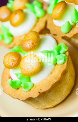 Three small cupcakes on plates Stock Photo