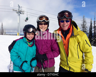 Family wearing ski gear on mountain Stock Photo