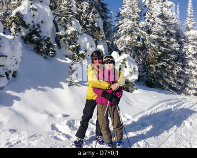 Father and daughter wearing ski gear outdoors Stock Photo