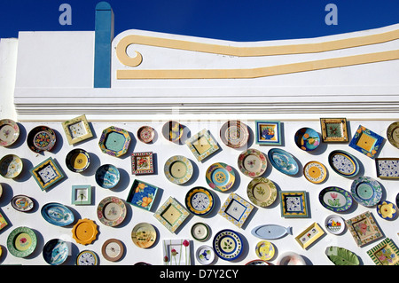 Traditional Portuguese hand painted plates decorating exterior of an artisan pottery wall in Cape St. Vincent next to the Sagres Point, on the so-called Costa Vicentina (Vincentine Coast), a headland in the municipality of Vila do Bispo, in the Algarve, southern Portugal. Stock Photo