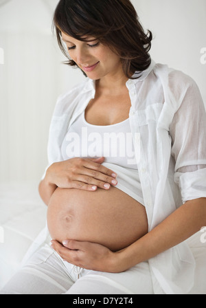 Pregnant woman holding her belly Stock Photo