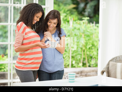 Pregnant woman showing friend sonogram Stock Photo