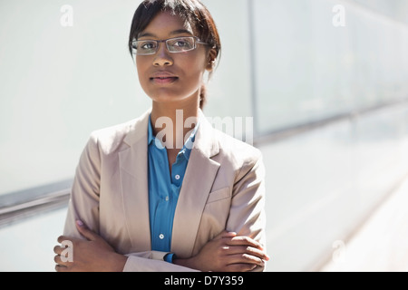 Businesswoman standing with arms crossed Stock Photo
