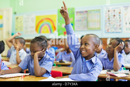 Student raising hand in class Stock Photo