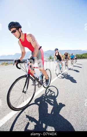 Cyclists in race on rural road Stock Photo