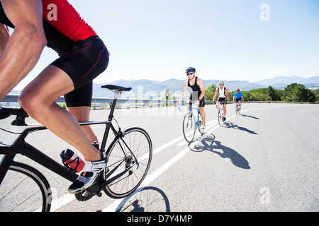 Cyclists in race on rural road Stock Photo