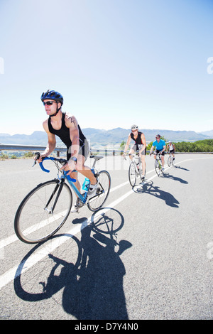 Cyclists in race on rural road Stock Photo