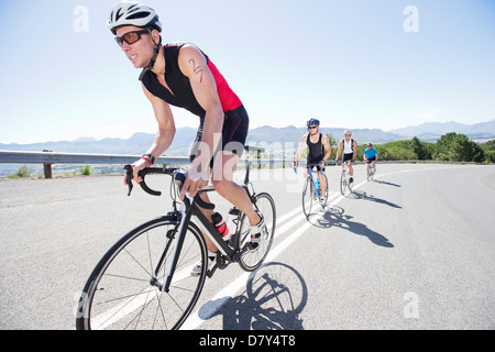 Cyclists in race on rural road Stock Photo