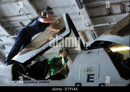 Sailors clean the canopy of an EA-6B Prowler. Stock Photo