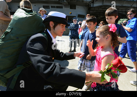 A sailor greets her family. Stock Photo