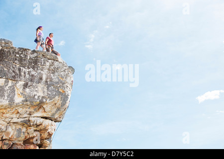 Climbers standing on rocky hilltop Stock Photo