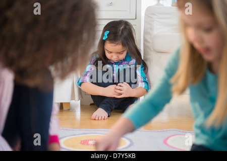 Girls playing without friend in living room Stock Photo