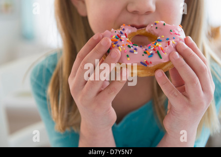 Caucasian girl eating donut Stock Photo
