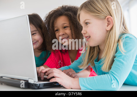 Girls using laptop together Stock Photo