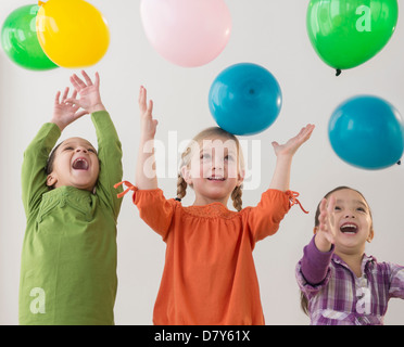 Girls playing with balloons Stock Photo