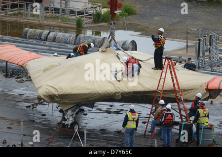 An X-47B is loaded onto flight deck of USS George H.W. Bush. Stock Photo