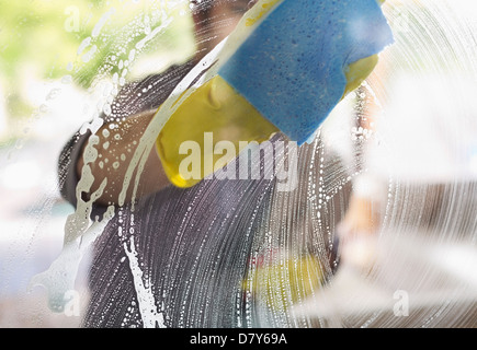 Man washing window with sponge Stock Photo