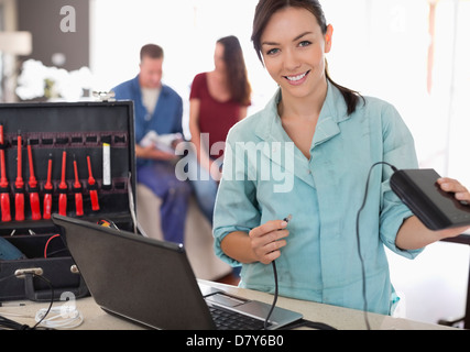 Female electrician using laptop in home Stock Photo