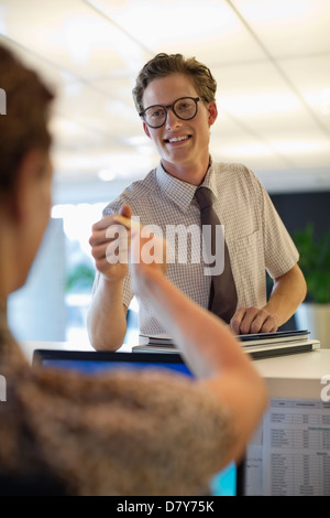Business people exchanging cards in office Stock Photo